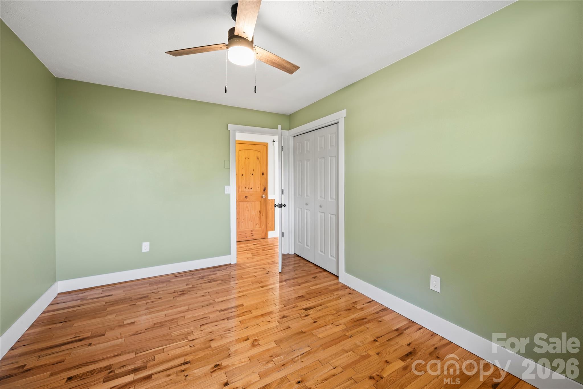 882 Queentown Road Canton, NC 28716 - Photo 17 of 33 a view of empty room with wooden floor and fan