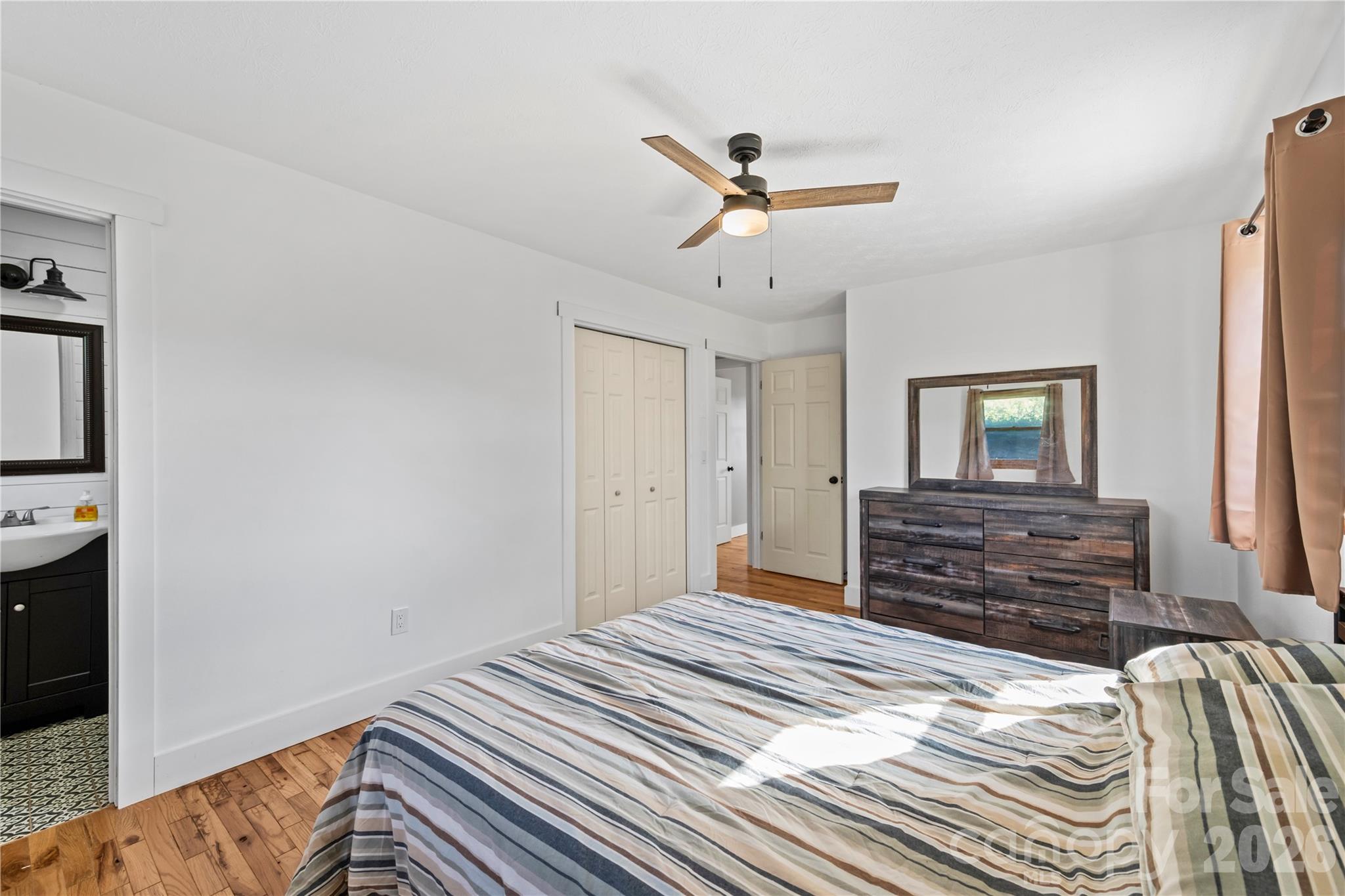 882 Queentown Road Canton, NC 28716 - Photo 20 of 33 a bedroom with a bed and wooden floor