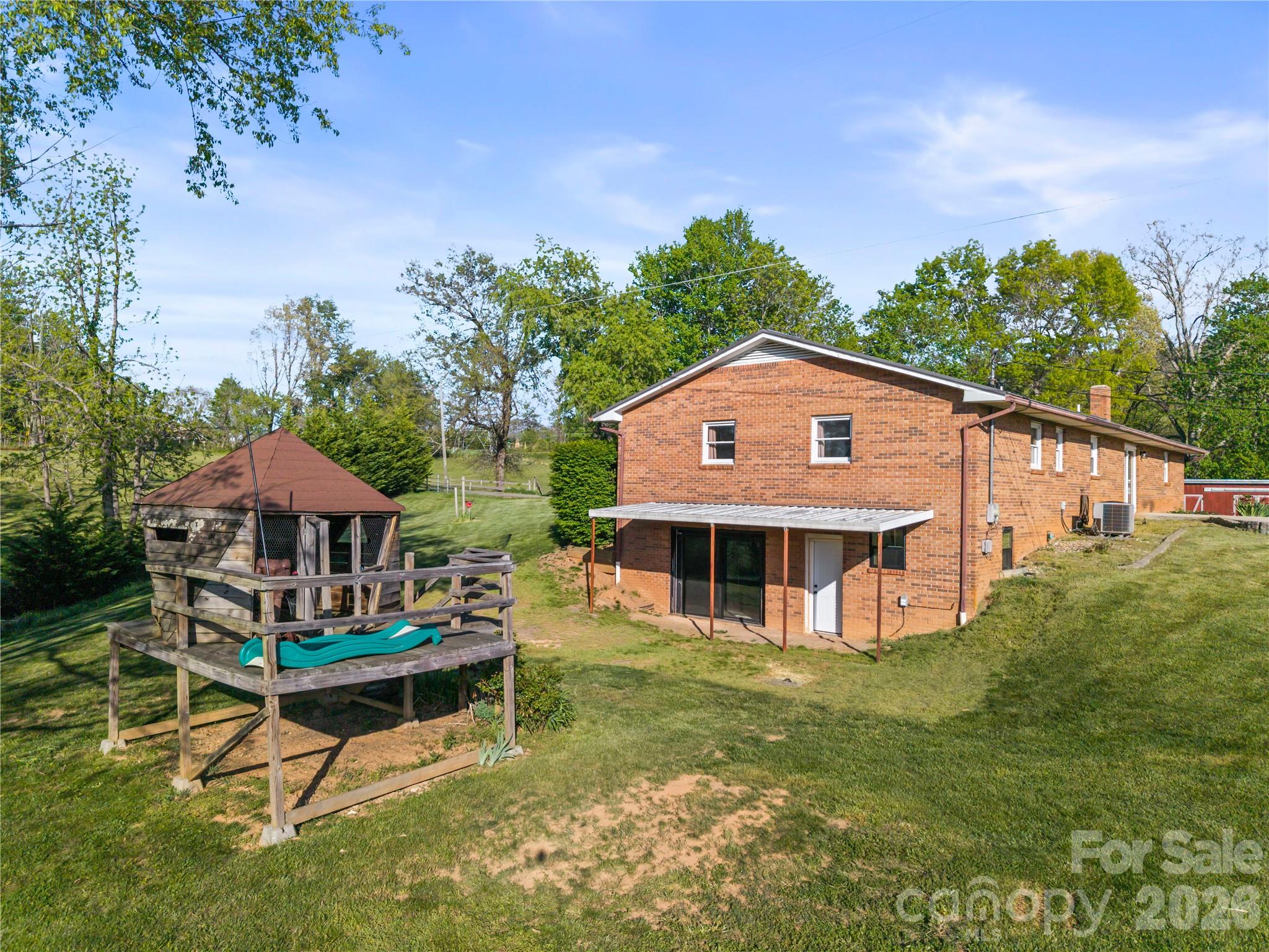 882 Queentown Road Canton, NC 28716 - Photo 2 of 33 a view of a house with a backyard porch and sitting area