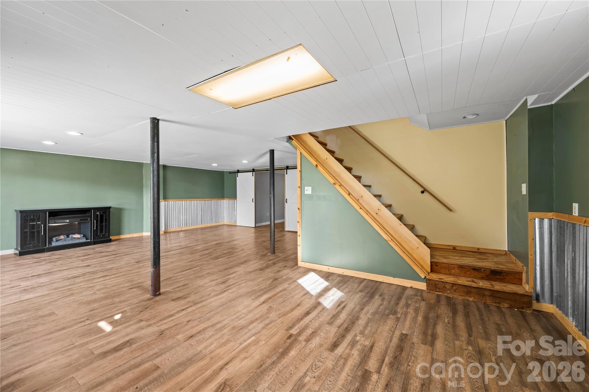 882 Queentown Road Canton, NC 28716 - Photo 22 of 33 a view of a livingroom with wooden floor and staircase