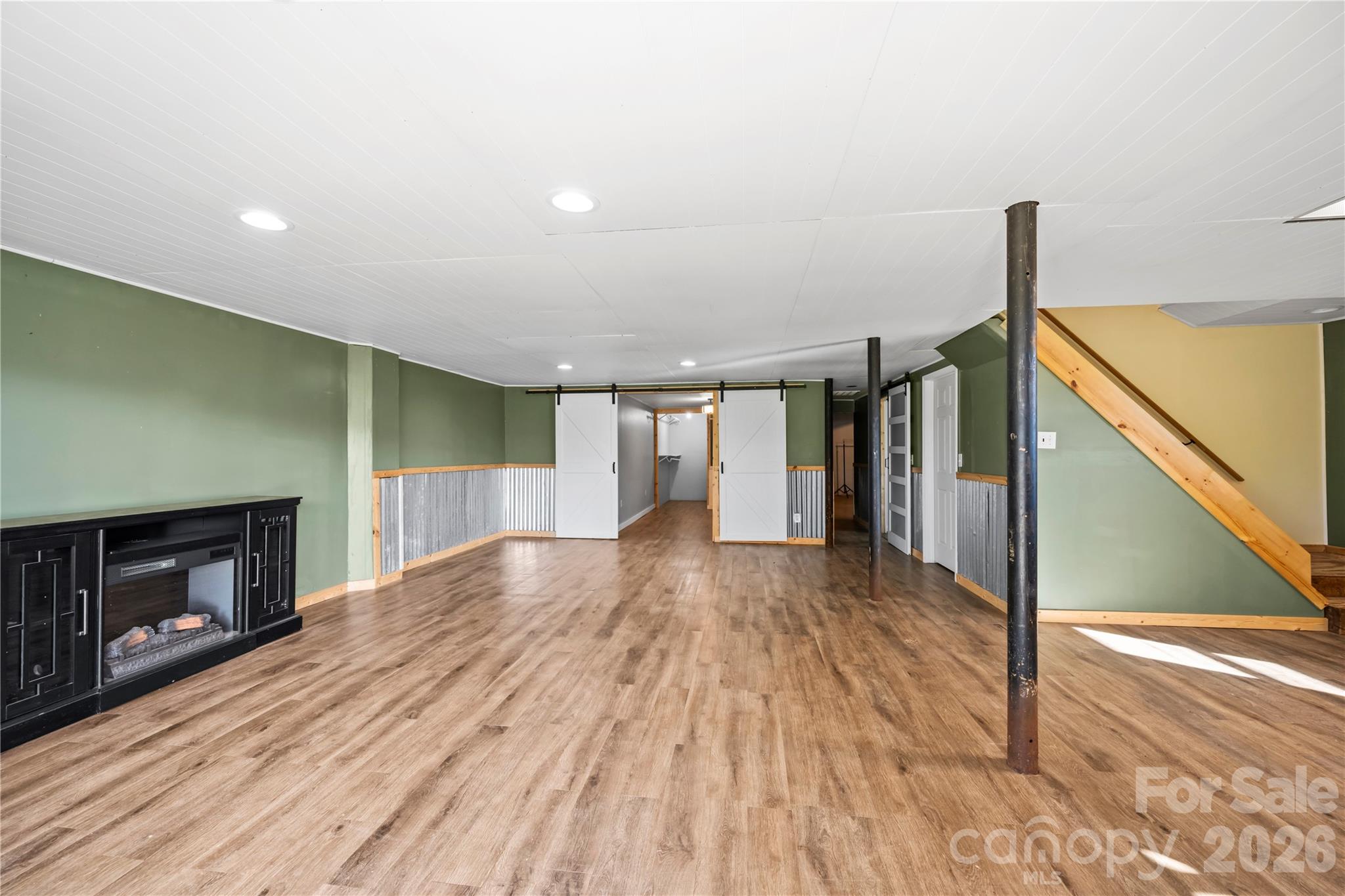 882 Queentown Road Canton, NC 28716 - Photo 23 of 33 a view of empty room with wooden floor and fan