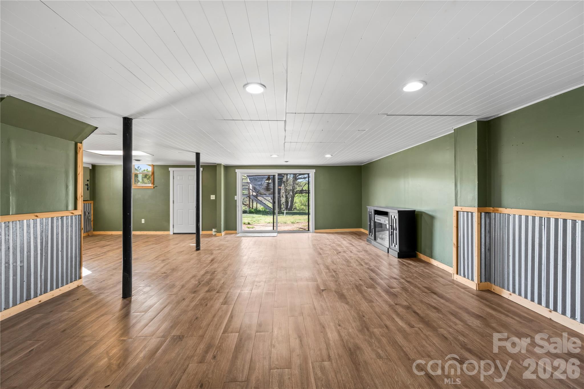 882 Queentown Road Canton, NC 28716 - Photo 24 of 33 an empty room with wooden floor and windows