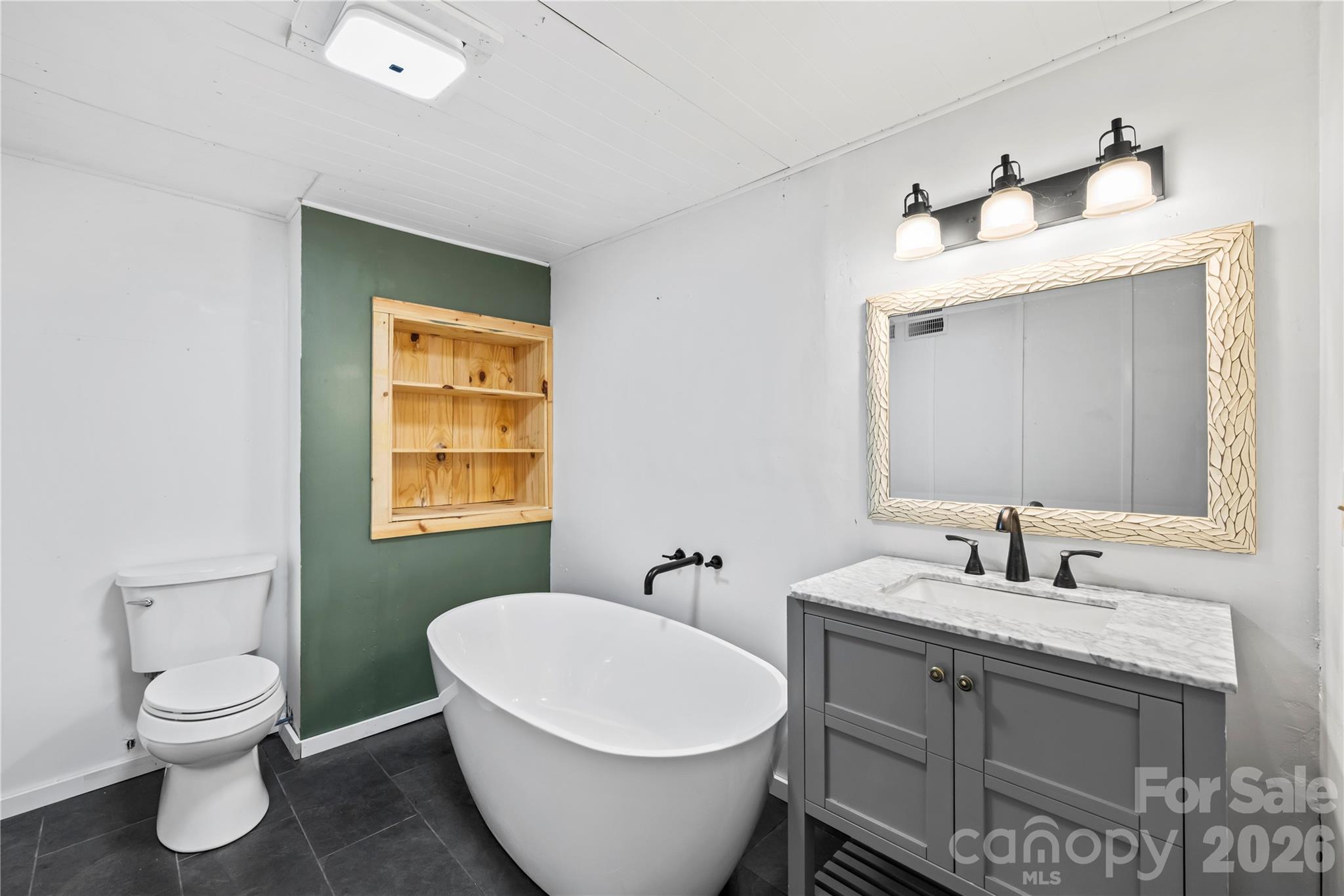 882 Queentown Road Canton, NC 28716 - Photo 26 of 33 a bathroom with a toilet sink and mirror