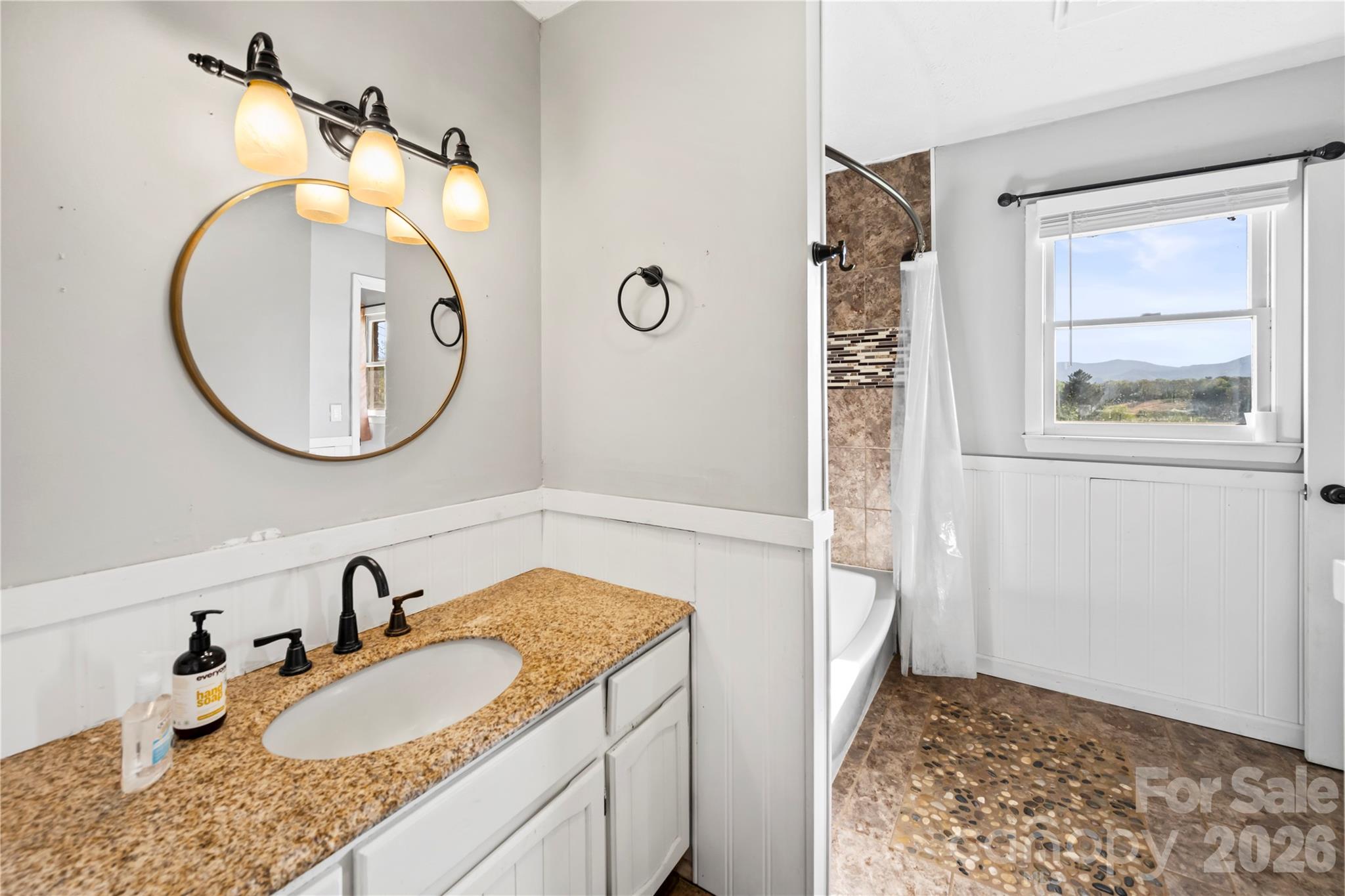 882 Queentown Road Canton, NC 28716 - Photo 28 of 33 a bathroom with a granite countertop sink mirror and vanity