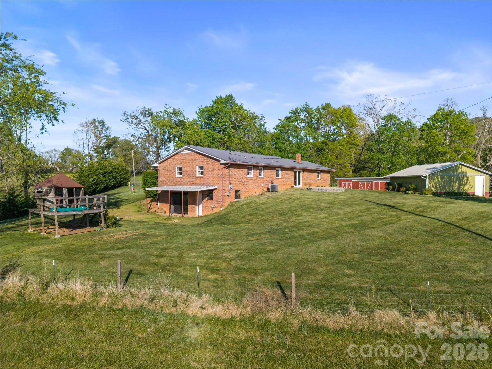 882 Queentown Road Canton, NC 28716 - Photo 6 of 33 a house with green field in front of it