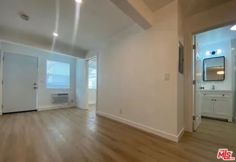 wooden floor in an empty room with a window