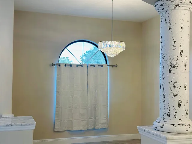 a view of a livingroom with furniture ceiling fan and window
