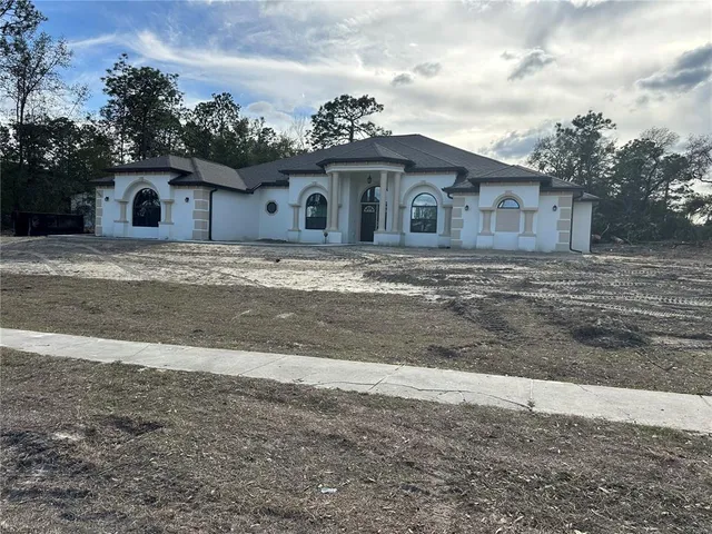 a big house with a big yard and large trees