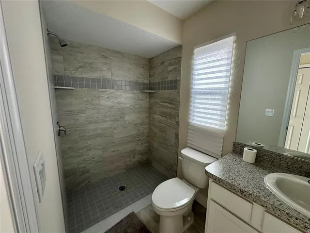 a spacious bedroom with a bed and a window