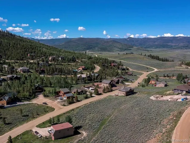 a view of a dry yard with trees