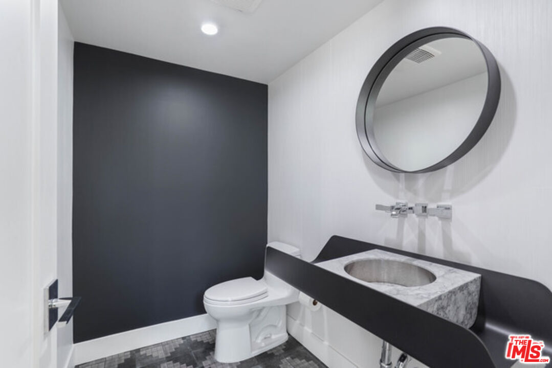 7263 Birdview Avenue Malibu, CA 90265 - Photo 11 of 17 a bathroom with a toilet a sink and mirror