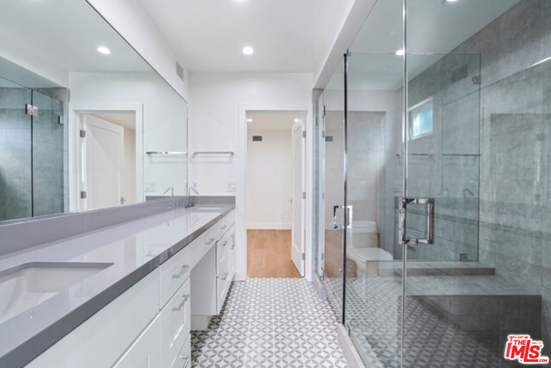 7263 Birdview Avenue Malibu, CA 90265 - Photo 5 of 17 a bathroom with a granite countertop sink mirror and shower