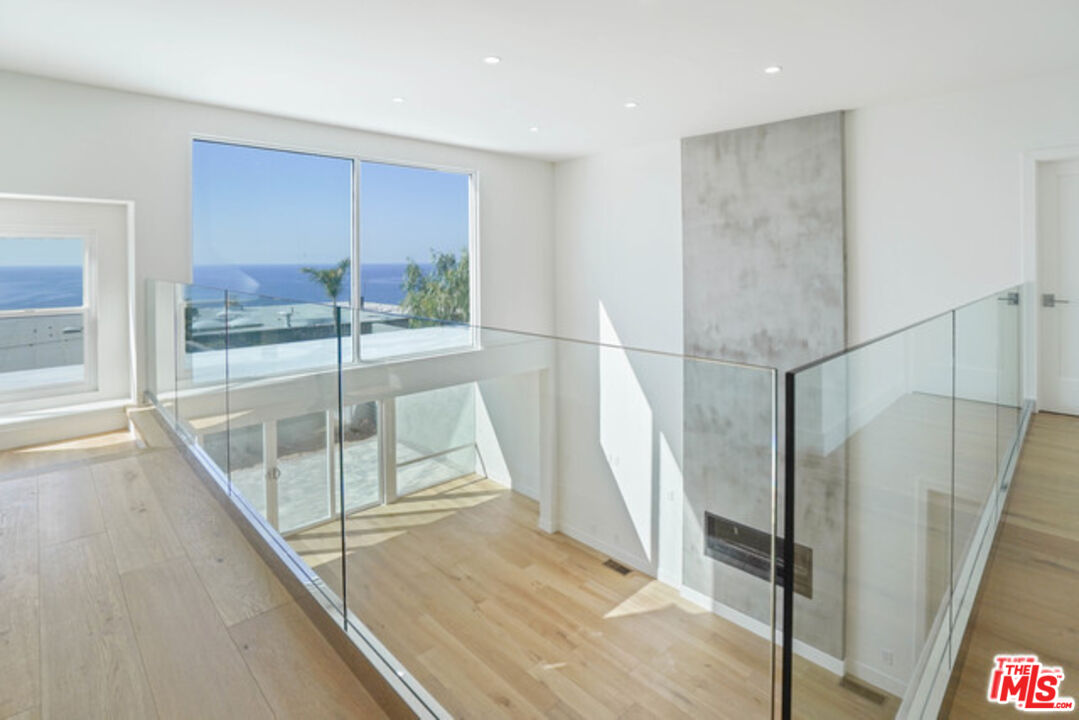7263 Birdview Avenue Malibu, CA 90265 - Photo 6 of 17 a view of entryway with wooden floor and door