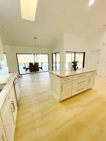 a view of a kitchen with a sink and cabinets