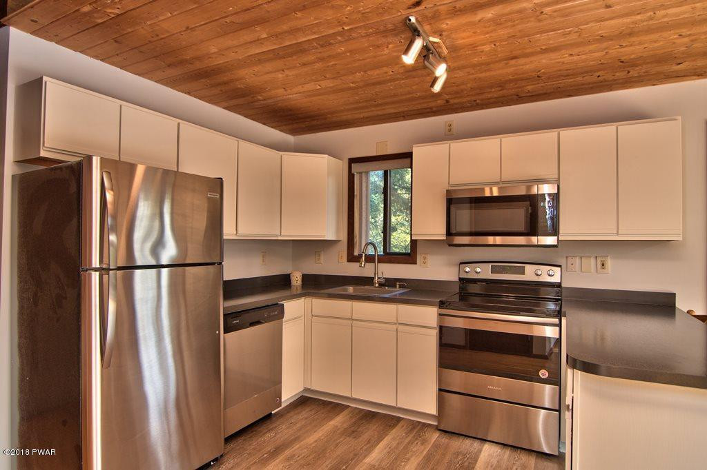 2412 Crest View Road Lake Ariel, PA 18436 - Photo 12 of 50 a kitchen with a refrigerator stove and microwave