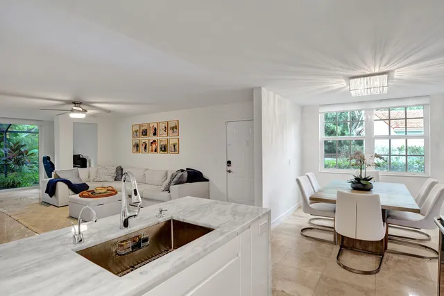 a living room with furniture a flat screen tv and a large window