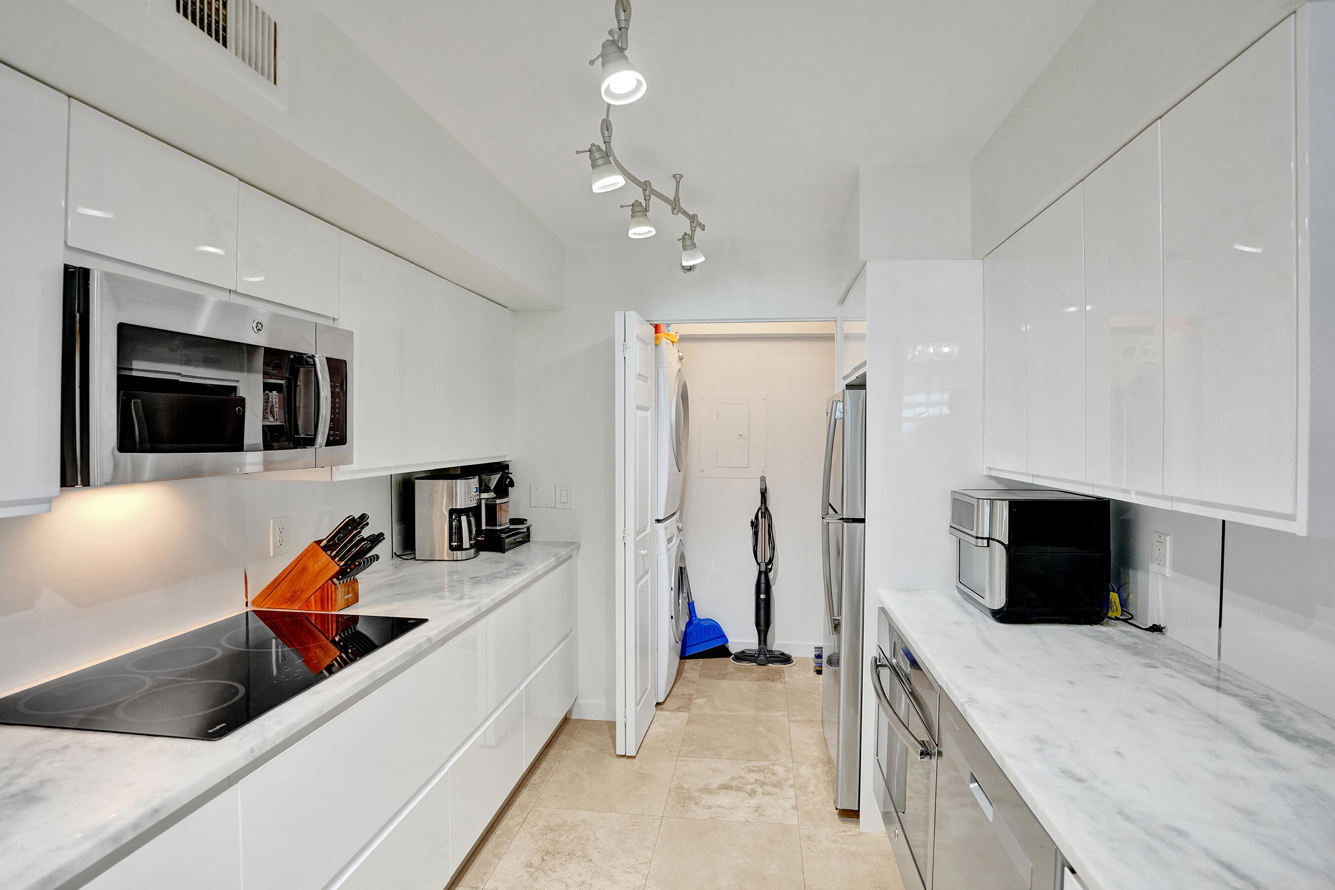 3237 Clint Moore Road, Unit 108 Boca Raton, FL 33496 - Photo 15 of 35 a room with furniture and a flat screen tv