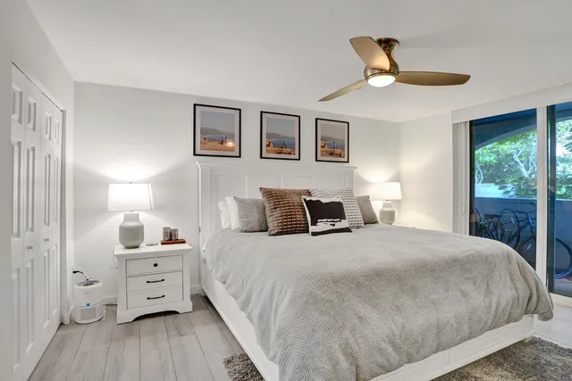 a bedroom with a large bed and a chandelier