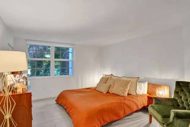 a bedroom with a bed and a mirror