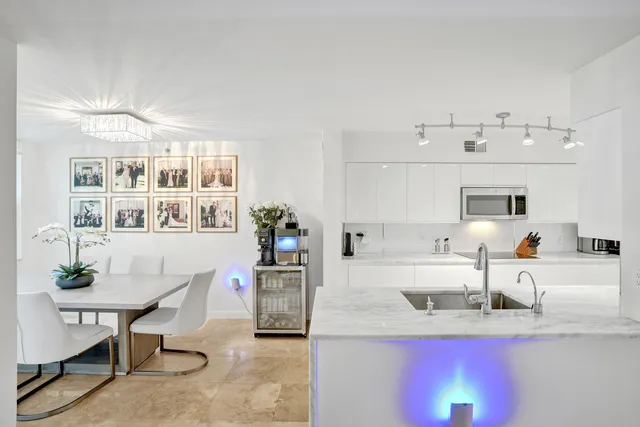 a dining room with furniture potted plants and wooden floor