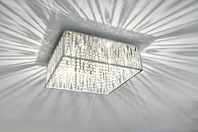 a large white kitchen with a stove a sink a faucet and a couch