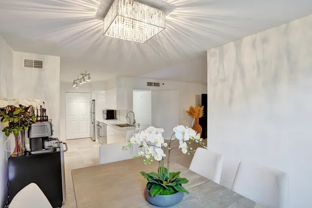 a kitchen with stainless steel appliances kitchen island granite countertop a refrigerator and a sink