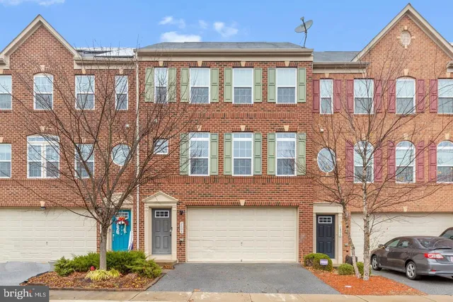 a front view of a residential apartment building with a yard
