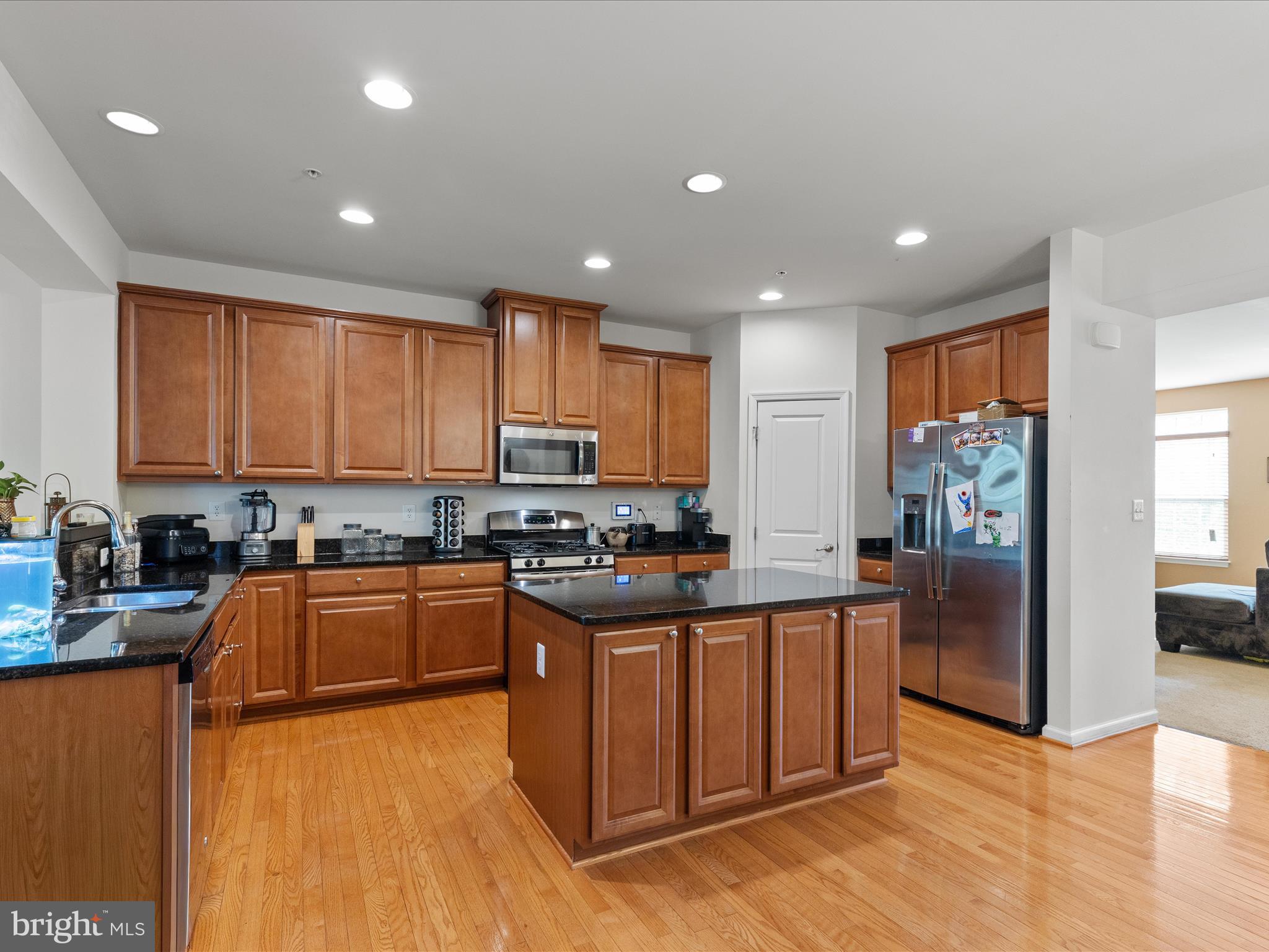 2804 St Marys View Road Accokeek, MD 20607 - Photo 14 of 37 a kitchen with stainless steel appliances granite countertop a stove top oven a sink dishwasher a refrigerator and cabinets with wooden floor