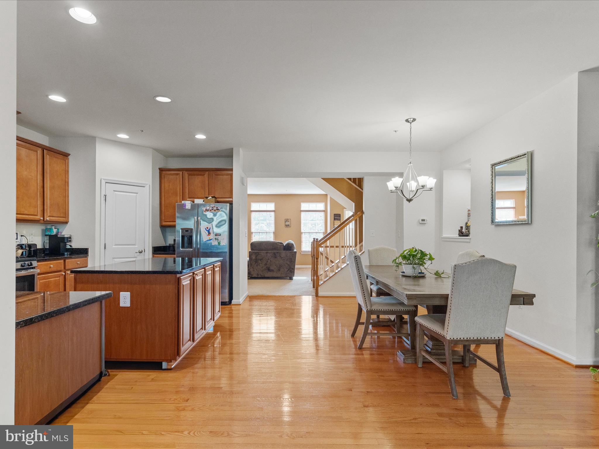 2804 St Marys View Road Accokeek, MD 20607 - Photo 17 of 37 a open kitchen with stainless steel appliances granite countertop a stove top oven a dining table and chairs with wooden floor