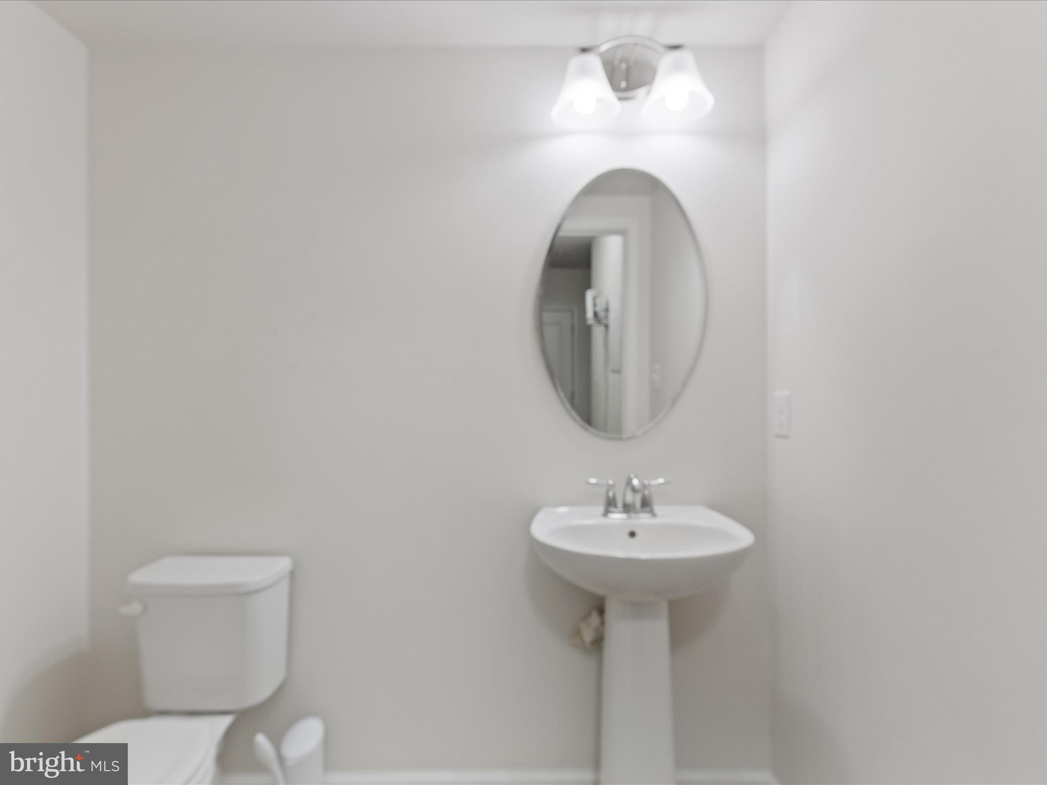 2804 St Marys View Road Accokeek, MD 20607 - Photo 32 of 37 a bathroom with a sink a mirror and toilet