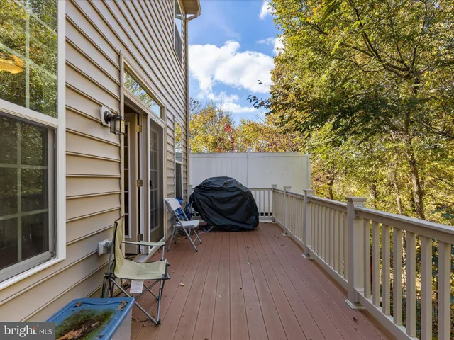a view of a balcony with chairs and a potted plant