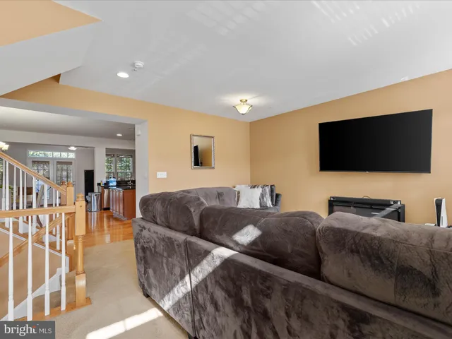 a living room with couches and a flat screen tv