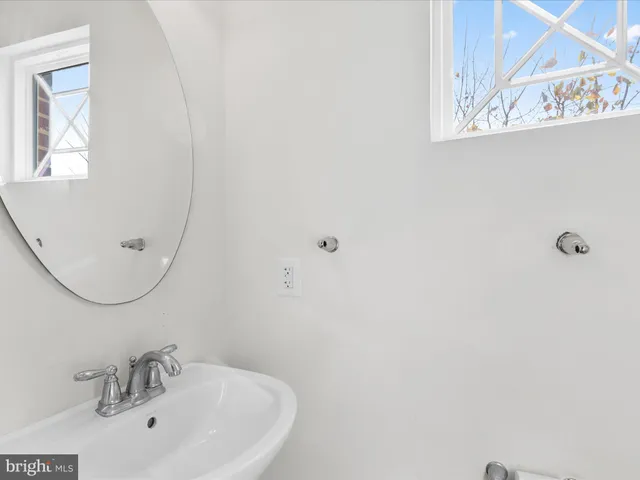 a bathroom with a sink and mirror