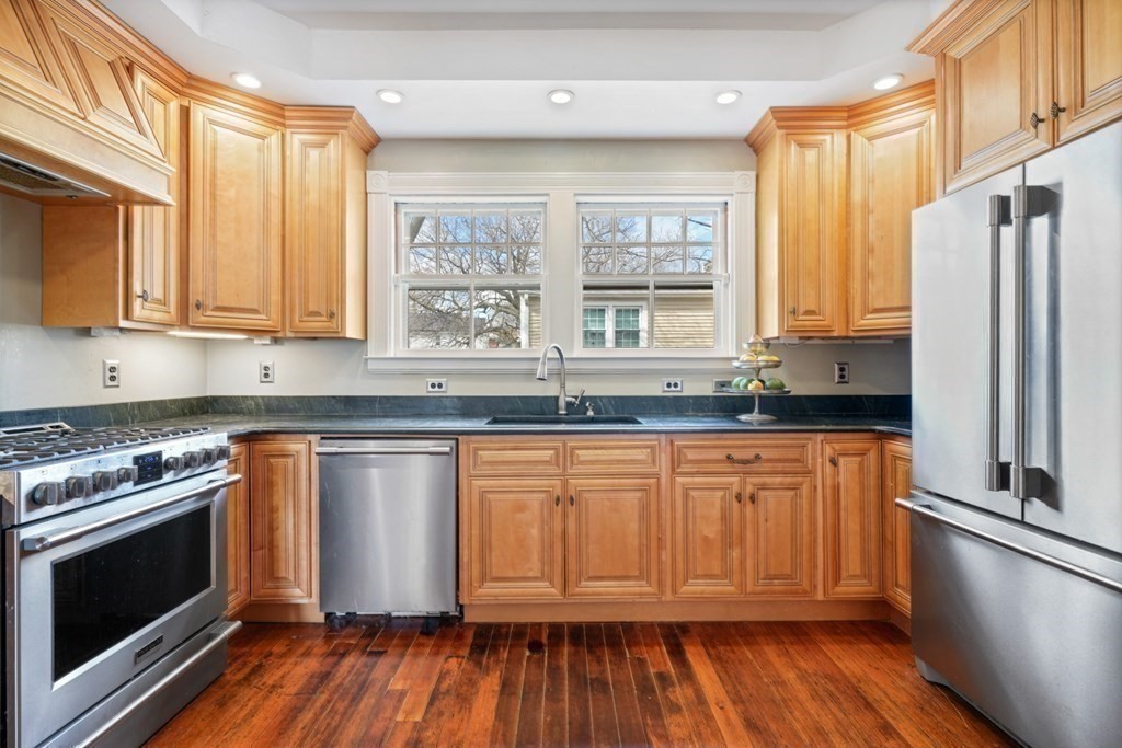 3 Rundel Park Boston, MA 02124 - Photo 13 of 31 a kitchen with stainless steel appliances granite countertop wooden floors and sink