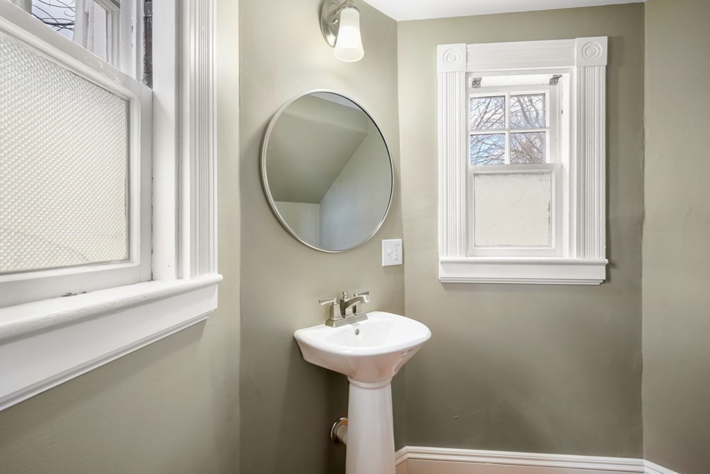 3 Rundel Park Boston, MA 02124 - Photo 18 of 31 a bathroom with a sink a mirror and a window