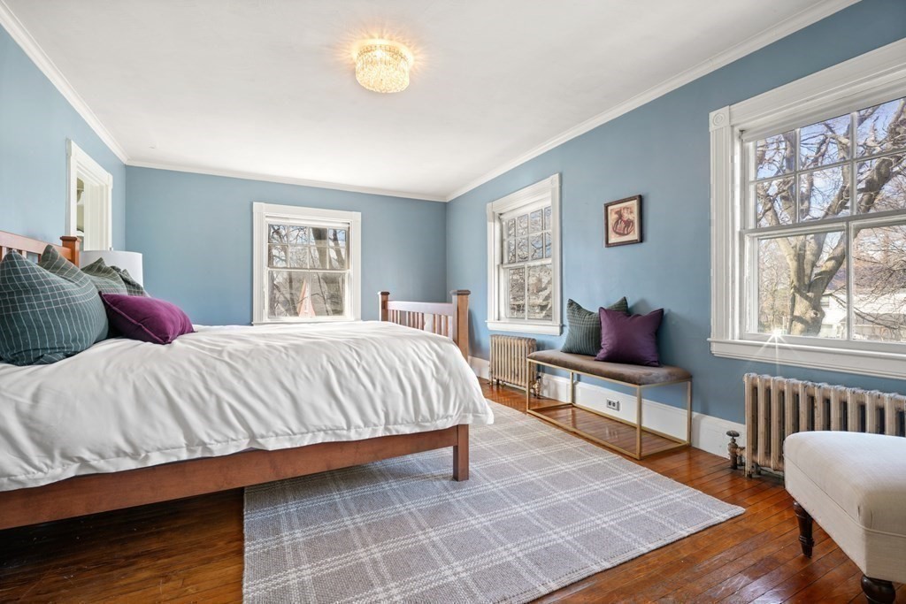 3 Rundel Park Boston, MA 02124 - Photo 20 of 31 a bedroom with a bed wooden floor and windows