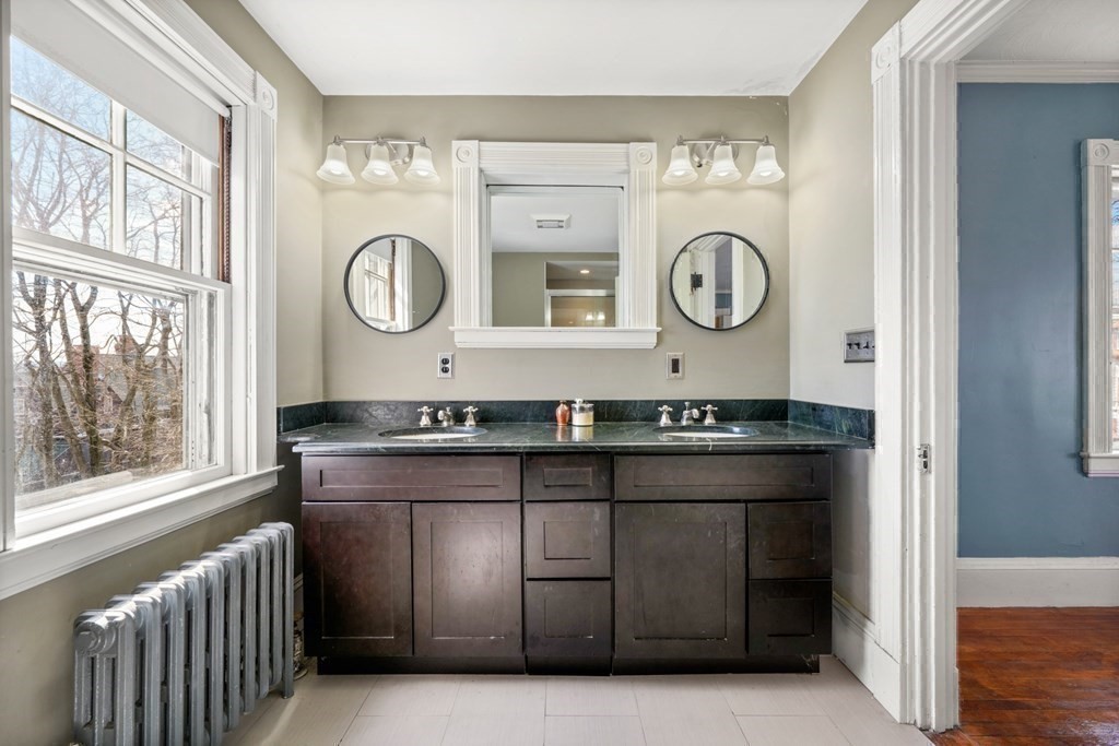 3 Rundel Park Boston, MA 02124 - Photo 22 of 31 a bathroom with a sink and a large mirror