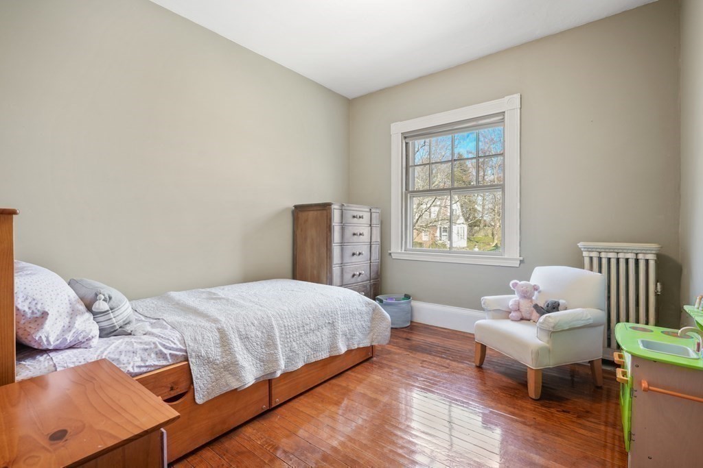 3 Rundel Park Boston, MA 02124 - Photo 24 of 31 a bedroom with a bed and wooden floor