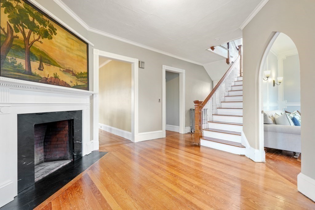3 Rundel Park Boston, MA 02124 - Photo 5 of 31 a view of a livingroom with wooden floor and a fireplace