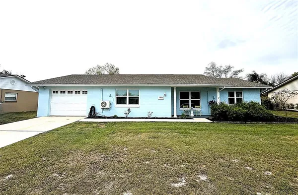 a front view of a house with a garden and yard