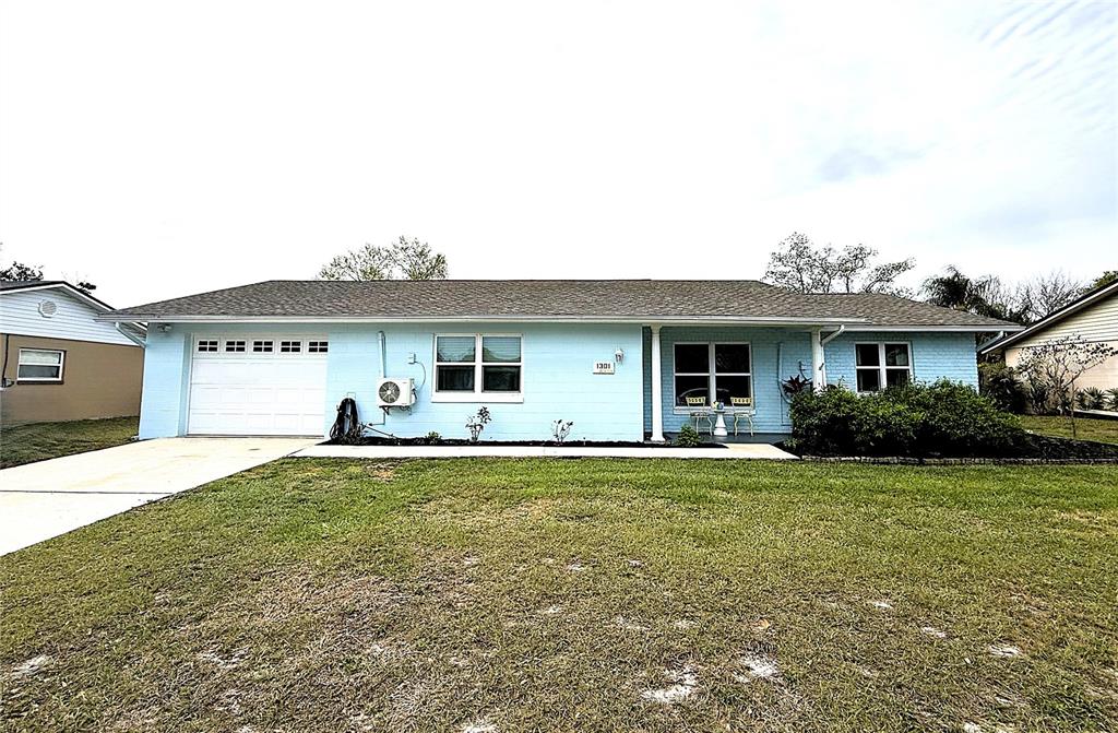 1301 Pinewood Lane Ocoee, FL 34761 - Photo 1 of 1 a front view of a house with a garden and yard