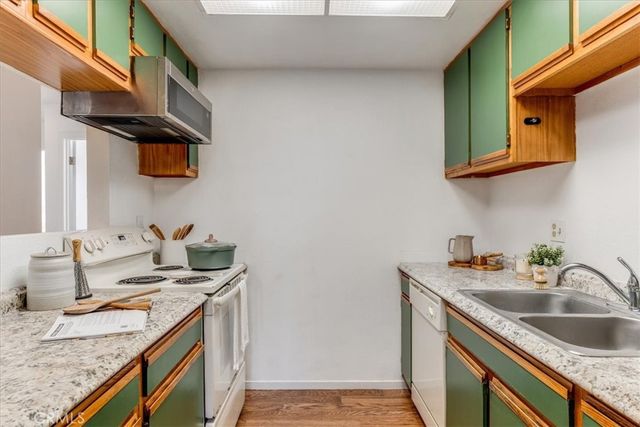 a kitchen with a sink cabinets and a wooden floor