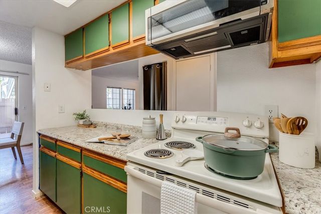 a kitchen with sink refrigerator and stove
