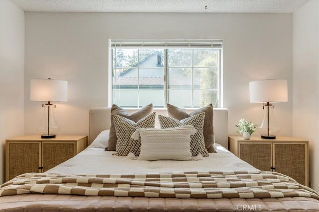 a bedroom with a bed and a painting on the wall