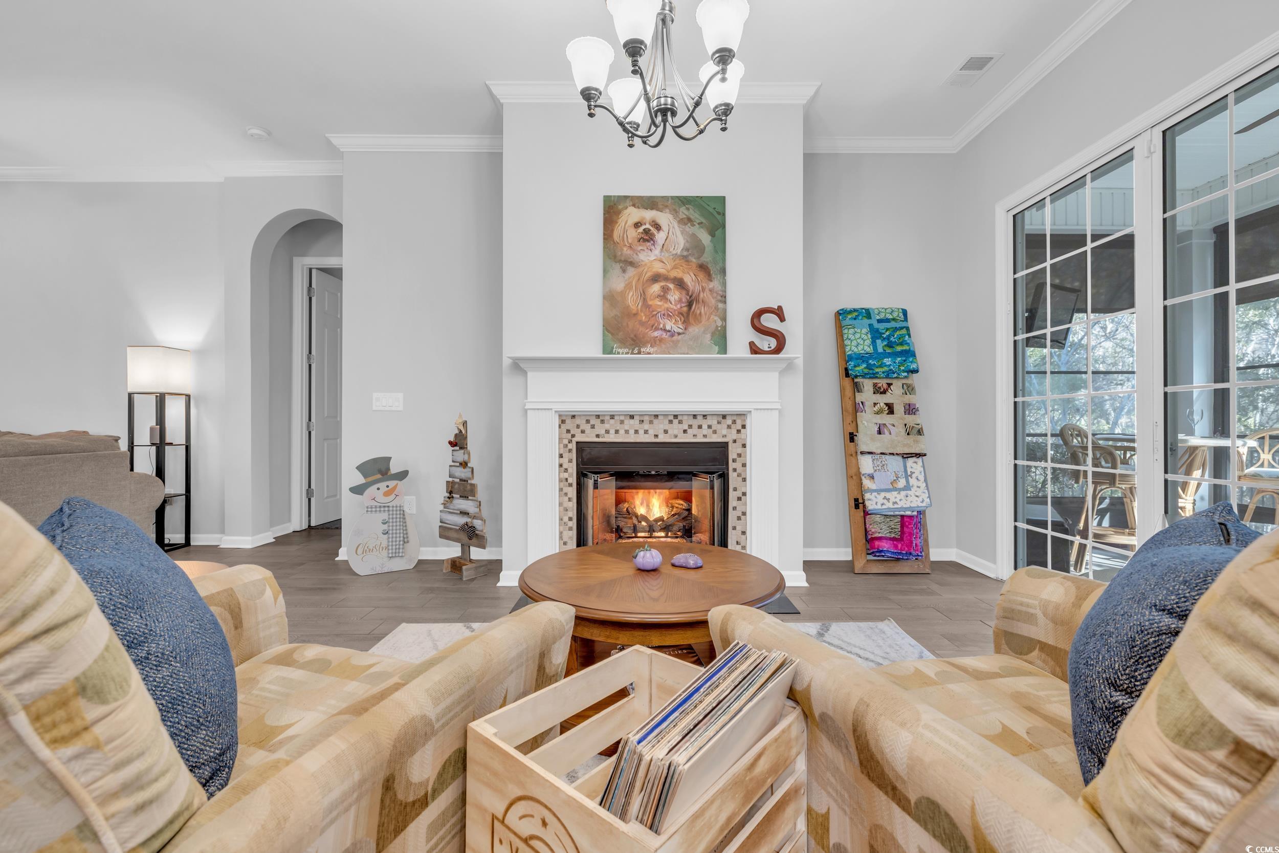 138 Sugar Loaf Lane Murrells Inlet, SC 29576 - Photo 18 of 38 Living area with an inviting chandelier, arched wa