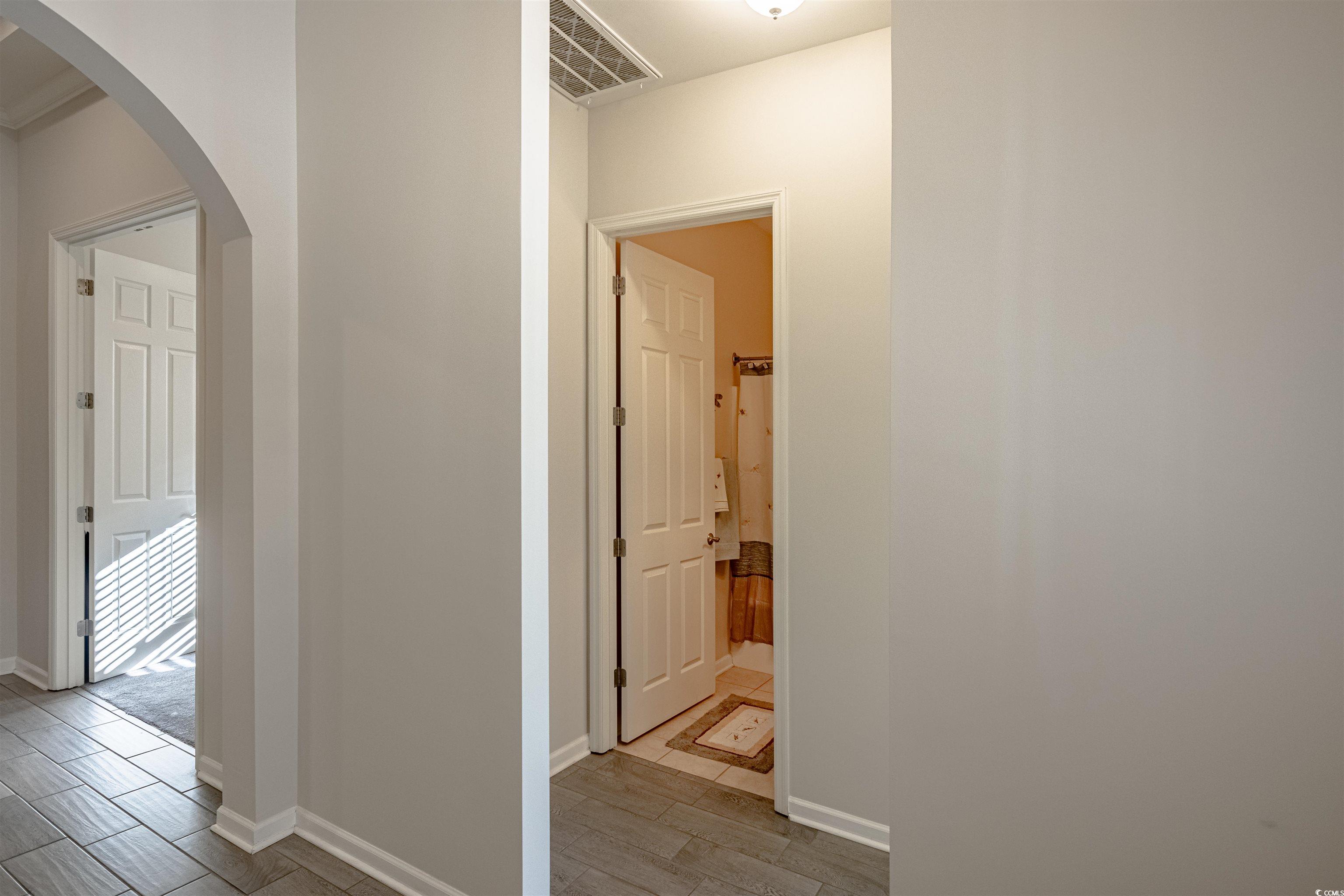 138 Sugar Loaf Lane Murrells Inlet, SC 29576 - Photo 8 of 38 Hallway featuring light hardwood / wood-style floo