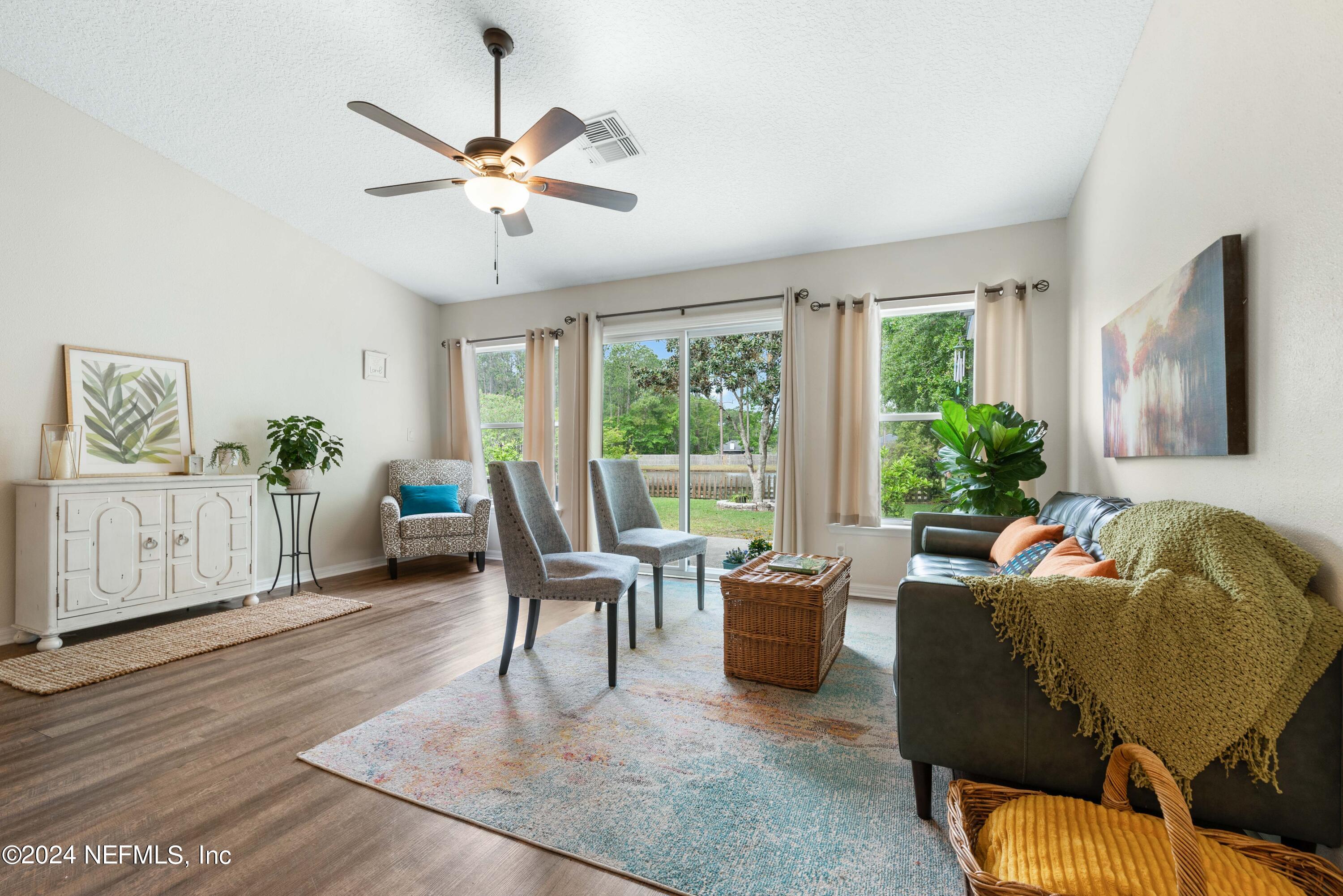 968 Deer Spring Drive Jacksonville, FL 32221 - Photo 12 of 31 a living room with furniture and a large window