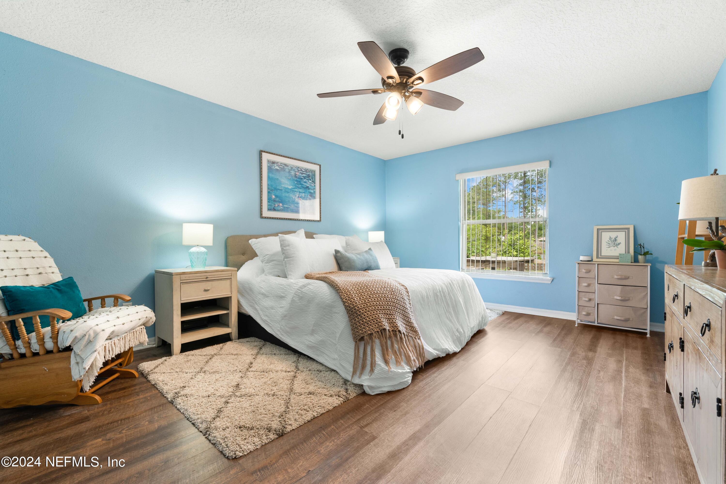 968 Deer Spring Drive Jacksonville, FL 32221 - Photo 17 of 31 a bedroom with a bed and wooden floor