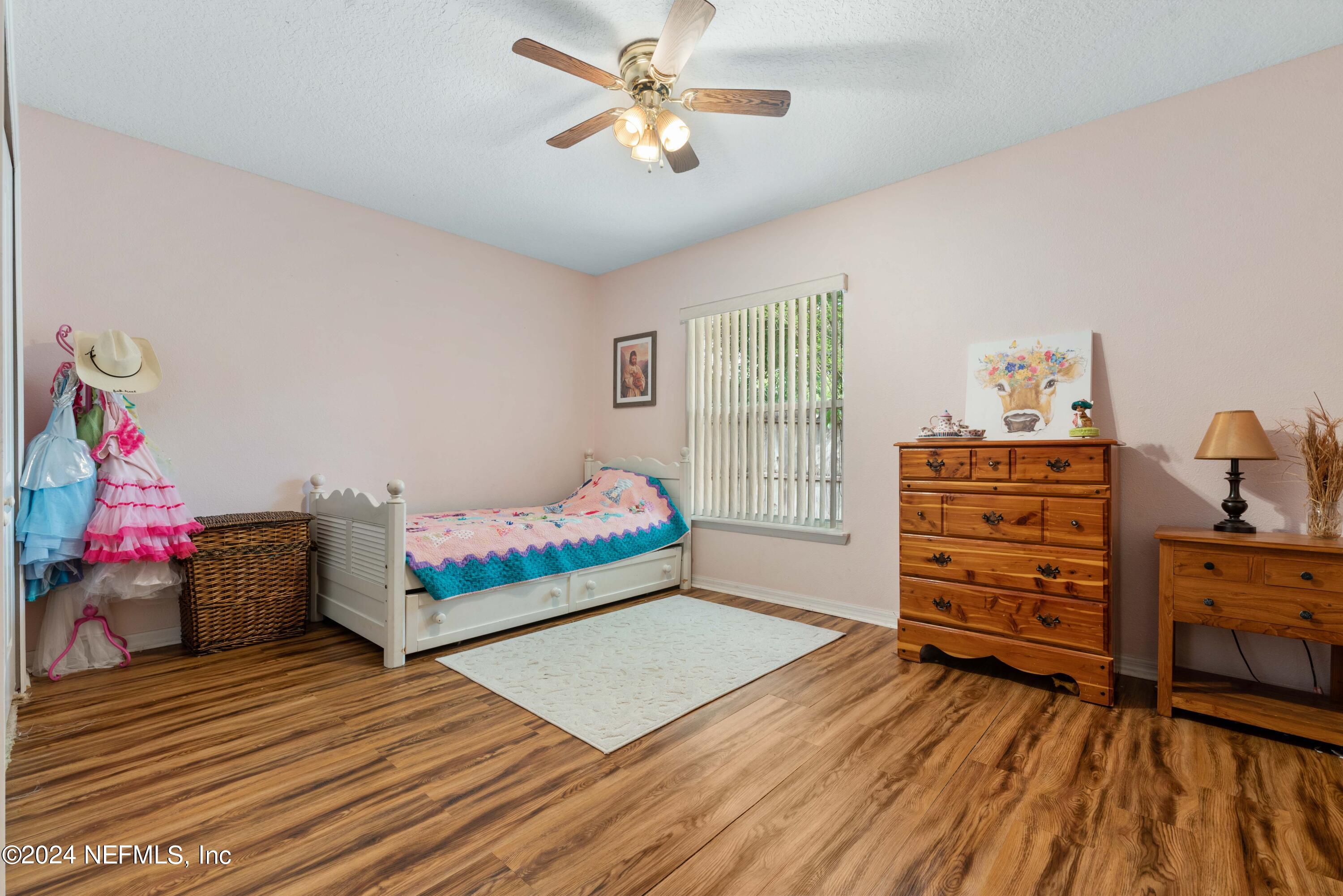 968 Deer Spring Drive Jacksonville, FL 32221 - Photo 20 of 31 a bedroom with a bed and wooden floor
