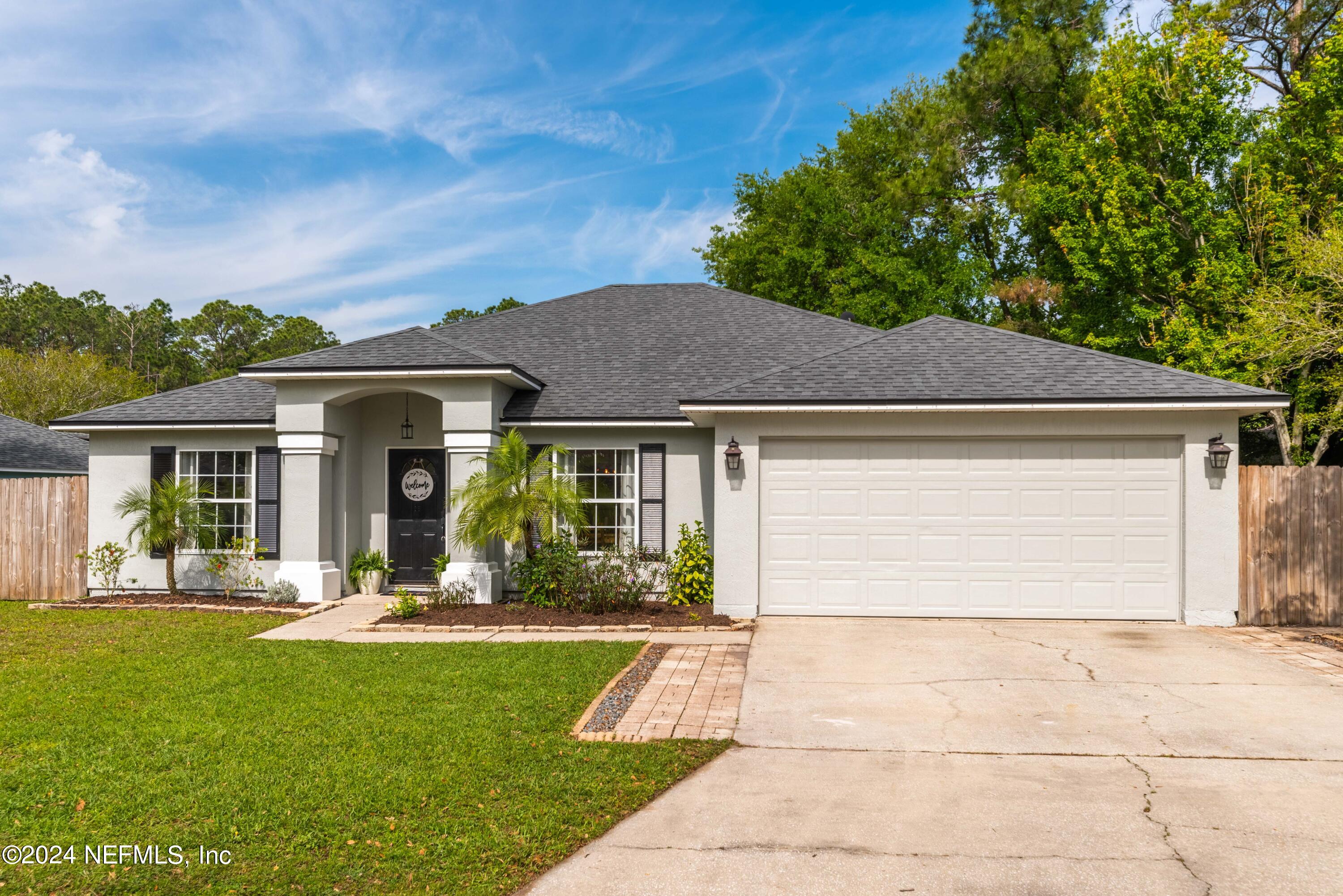 968 Deer Spring Drive Jacksonville, FL 32221 - Photo 2 of 31 a front view of a house with a yard
